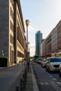 Vertical shot of a busy street with heavy traffic in the middle of buildings and sidewalks