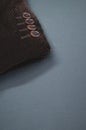 Vertical shot of the buttons of the sleeve of a brown corduroy jacket placed on a gray surface