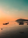 Vertical shot of a calm bay with boats during the sunset Royalty Free Stock Photo