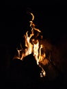 Vertical shot of a campfire in the darkness Royalty Free Stock Photo