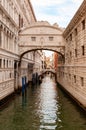 Vertical shot of a canal surrounded by typical buildings in Venice, Italy