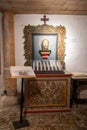 Vertical shot of candles and a memorial inside the Janeza Krstnika church in Bohinj, Slovenia