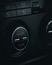Vertical shot of a car air conditioner control panel black buttons on the black background Royalty Free Stock Photo