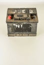 Vertical shot of a car battery on a white surface Royalty Free Stock Photo