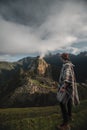Vertical shot of a Caucasian hiker overlooking Machu Pichu in Peru