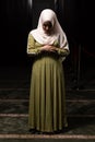 Vertical shot of a Caucasian muslim woman wearing the Islamic Long Hijab Khimar inside a mosque