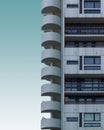 Vertical shot of a cement building with round stairway on a blue background