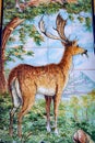 Vertical shot of a ceramic wall of a deer in he forest in Talavera de la Reina