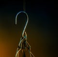 Vertical shot of chains hanging from a hook