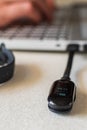 Vertical shot of charging smart band on laptop Royalty Free Stock Photo