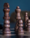 Vertical shot of chess figures - the concept of overcoming the challenges and succeeding