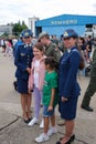 Vertical shot of children and female air force officers at Bucharest International Air Show