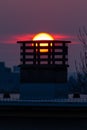 Vertical Shot Of A Chimney Of A Building With The Stunning View Of Sunset In The Background