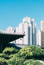 Vertical shot of Chinses temple roof against the background of modern buildings. Kowloon, Hong Kong.