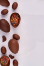 Vertical shot chocolate eggs with rainbow sprinkles.