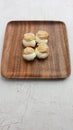 Vertical shot of choux pastry buns on a wooden plate Royalty Free Stock Photo