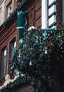 Vertical shot of Christmas Decors and Santa on a wall of a building in Tbilisi