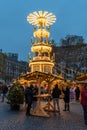 Vertical shot of a Christmas pyramid in Rossmarkt Christmas market in the evening, Frankfurt