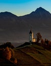 Vertical shot of The Church of St. Primoz and Felicijan on an evergreen hill in Jamnik, Slovenia Royalty Free Stock Photo