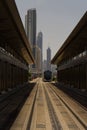 Vertical shot of the cityscape of Dubai with a symmetrical view of the tram railroads.