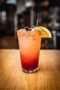 Vertical shot of a classic margarita cocktail with a slice of lime and salty rim on bar counter Royalty Free Stock Photo