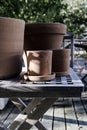 Vertical shot of clay pots of different sizes on a wooden coffee table Royalty Free Stock Photo