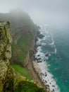 Vertical shot of cliff by the sea surro Royalty Free Stock Photo