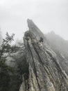 Vertical shot of a climber on the fixed rope route on a cloudy day Royalty Free Stock Photo