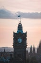 Vertical shot of a clock tower in Edinburgh, United Kingdom at sunset