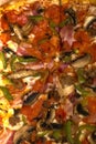 Vertical shot of closeup pizza with mushrooms and green pepper.