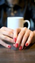 Vertical shot. closeup. the woman takes off her wedding ring sitting in a cafe Royalty Free Stock Photo