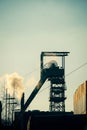 Vertical shot of coal mining equipment near the smoke outdoors Royalty Free Stock Photo