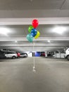 Vertical shot of colorful ballons in a parking garage Royalty Free Stock Photo