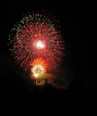 Vertical shot of the colorful fireworks shining bright in the dark black night sky Royalty Free Stock Photo