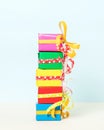 Vertical shot of colorful gift boxes stacked on a pastel background Royalty Free Stock Photo