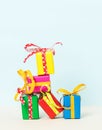 Vertical shot of colorful gift boxes stacked on a pastel background Royalty Free Stock Photo