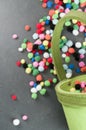 Vertical Shot Of Colorful Small Cloth Softballs On A Green Bucket
