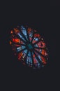 Vertical shot of a colorful stained glass window from inside the cathedral on a black background. Royalty Free Stock Photo