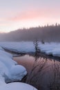 Vertical shot of a colorful Winter sunset enveloped in fog at Gold Creek, Washington Royalty Free Stock Photo