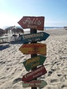 Vertical shot of colorful wooden signs on the beach