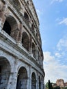 Vertical shot of the Colosseum building under the blue sunny sky, Rome, Italy