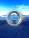 Vertical shot of a concrete statue of a hole with the beautiful view of the sea in the background Royalty Free Stock Photo