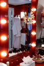 Vertical shot of a console mirror with lamps in a hotel room with shampoos on the table Royalty Free Stock Photo