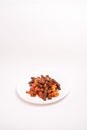 Vertical shot of cooked black penne pasta with shrimp in a plate isolated on a white background Royalty Free Stock Photo