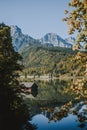 Vertical shot of the countryside with a small red barn located on the lake Royalty Free Stock Photo