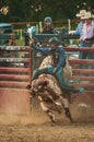 Vertical shot of a cowboy riding a bull at the Wyandotte County Kansas Fair Rodeo