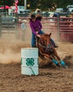 Vertical shot of a cowgirl barrel racing at the Wyandotte County Kansas Fair Rodeo Royalty Free Stock Photo