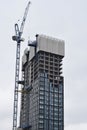 Vertical shot of crane near building in London Royalty Free Stock Photo