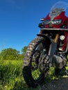 Vertical shot of a CRF1000L Honda Africa Twin adventure bike on a sunny field