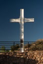 Vertical shot of the Cross of the Martyrs against a blue sky on the hilltop in Santa Fe, New Mexico